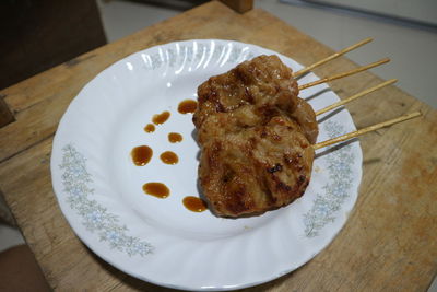 High angle view of hand holding food in plate