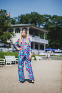 Full length of young woman standing outdoors