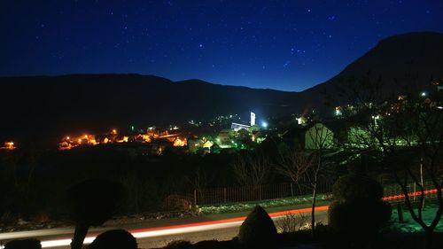 Panoramic view of illuminated mountain against sky at night