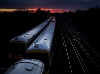 High angle view of train on railroad tracks against sky during sunset