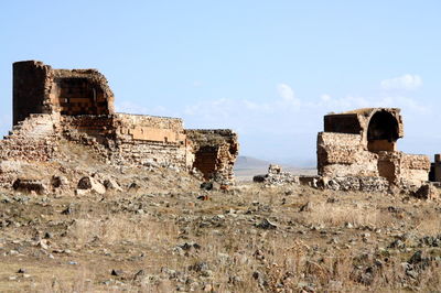Old ruins on field against sky