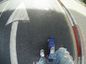 Low section of person standing on road