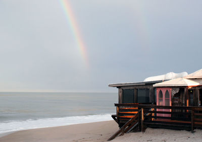 Scenic view of rainbow over sea against sky