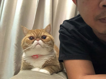 Portrait of man with cat at home