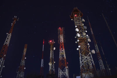 Low angle view of illuminated buildings against sky at night