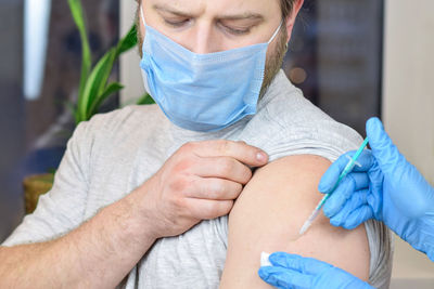 Man getting vaccinated. coronavirus, flu, covid-19 vaccinatio. doctor giving  injection to patient.