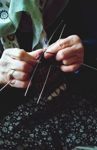 Midsection of woman knitting wool