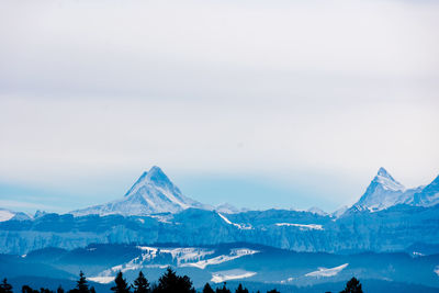 Scenic view of snowcapped mountains against sky