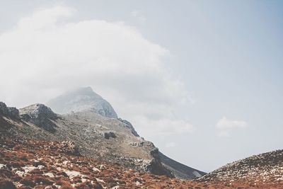 Scenic view of mountains against cloudy sky