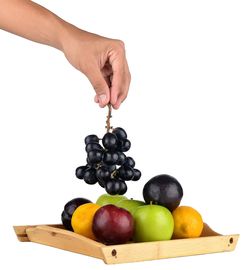 Various fruits in container against white background