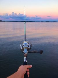 Fisherman with rod at dusk