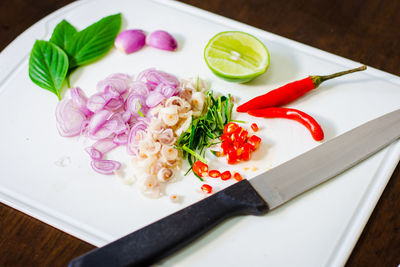 High angle view of chopped fruits in plate on table