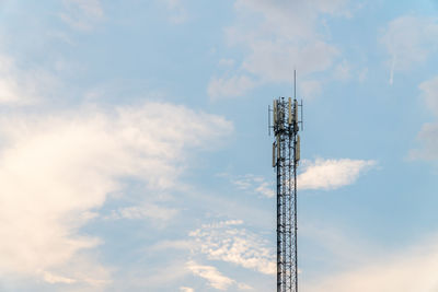 Low angle view of communications tower against sky