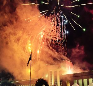 Low angle view of firework display at night