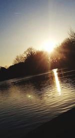 Scenic view of lake against sky during sunset