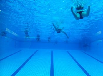 Swimming underwater in pool