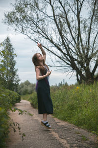 Full length of woman standing on field