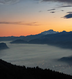 Scenic view of silhouette mountains against sky at sunset