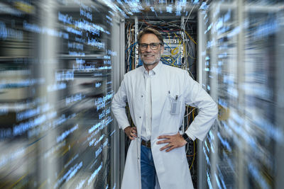 Portrait of smiling man standing in corridor