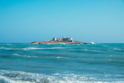 Scenic view of sea against clear blue sky