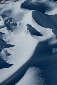 High angle view of person shadow on snow covered landscape