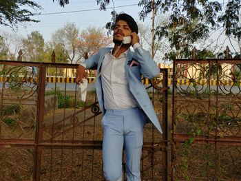 Full length of man using mobile phone