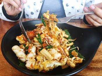 Close-up of person holding food on table