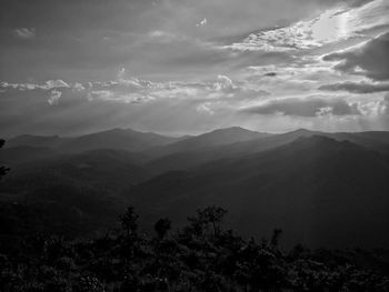 Scenic view of mountains against cloudy sky