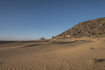 Shapes and patterns at great dune in the sahara desert in the afternoon light