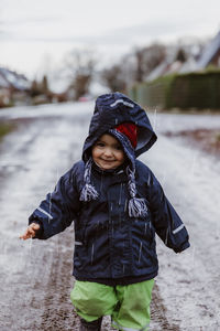 Baby girl standing on road during winter