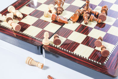 High angle view of chess board over white background