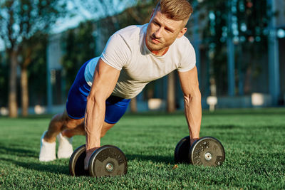 Man exercising on field