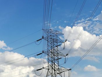 Low angle view of electricity pylon against sky