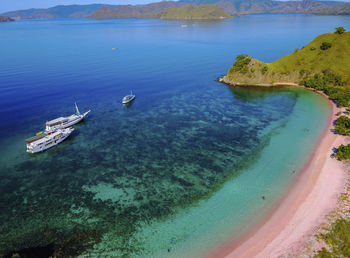 High angle view of sailboats on sea shore on flores island, indonesia