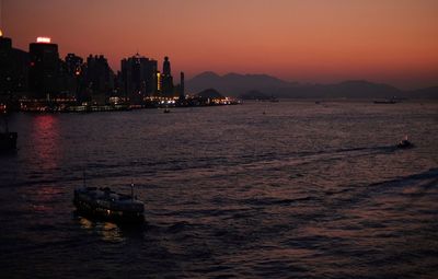 Boat in sea at sunset