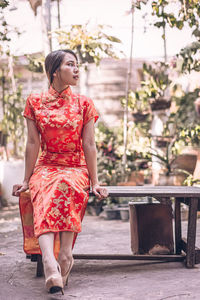 Full length of woman sitting on bench