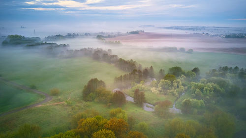 Summer cloudy rainy foggy morning panorama. rural misty river, fields, meadow, spring overcast moody