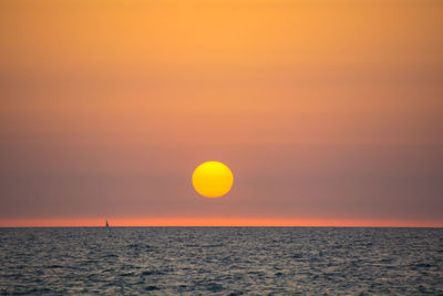 Scenic view of sea against romantic sky at sunset