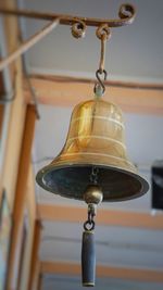 Low angle view of electric lamp hanging from ceiling