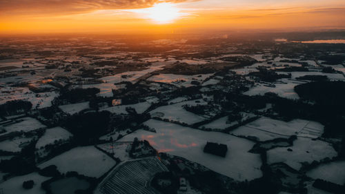 High angle view of buildings in city during sunset