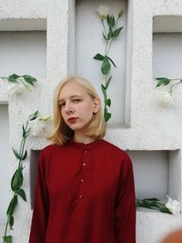 Close-up of girl standing against wall