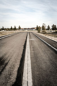 Empty country road against sky