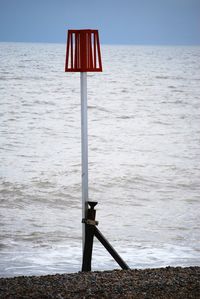 Close-up of lifeguard hut on beach against sky