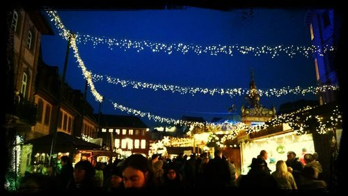 People in illuminated city at night