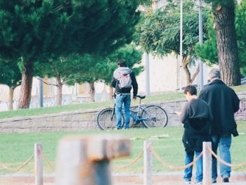 People on bicycle against trees