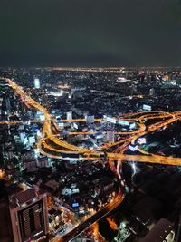 High angle view of illuminated cityscape against sky at night