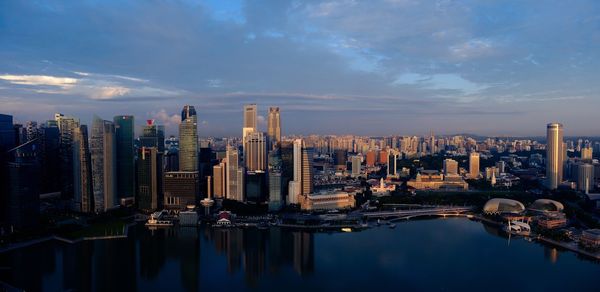 Aerial view of city lit up at waterfront