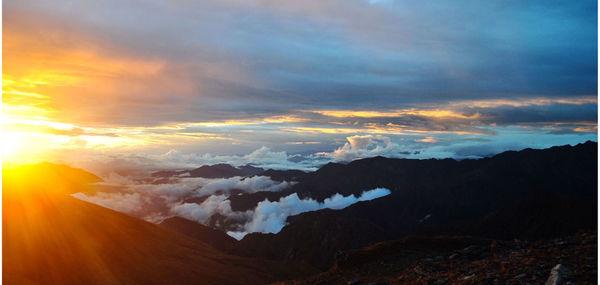 Scenic view of mountains against cloudy sky