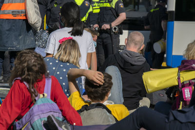 Rear view of people standing on street