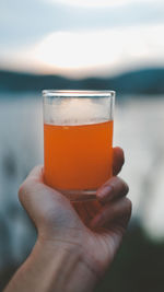 Fruit juice at the lake at sunset